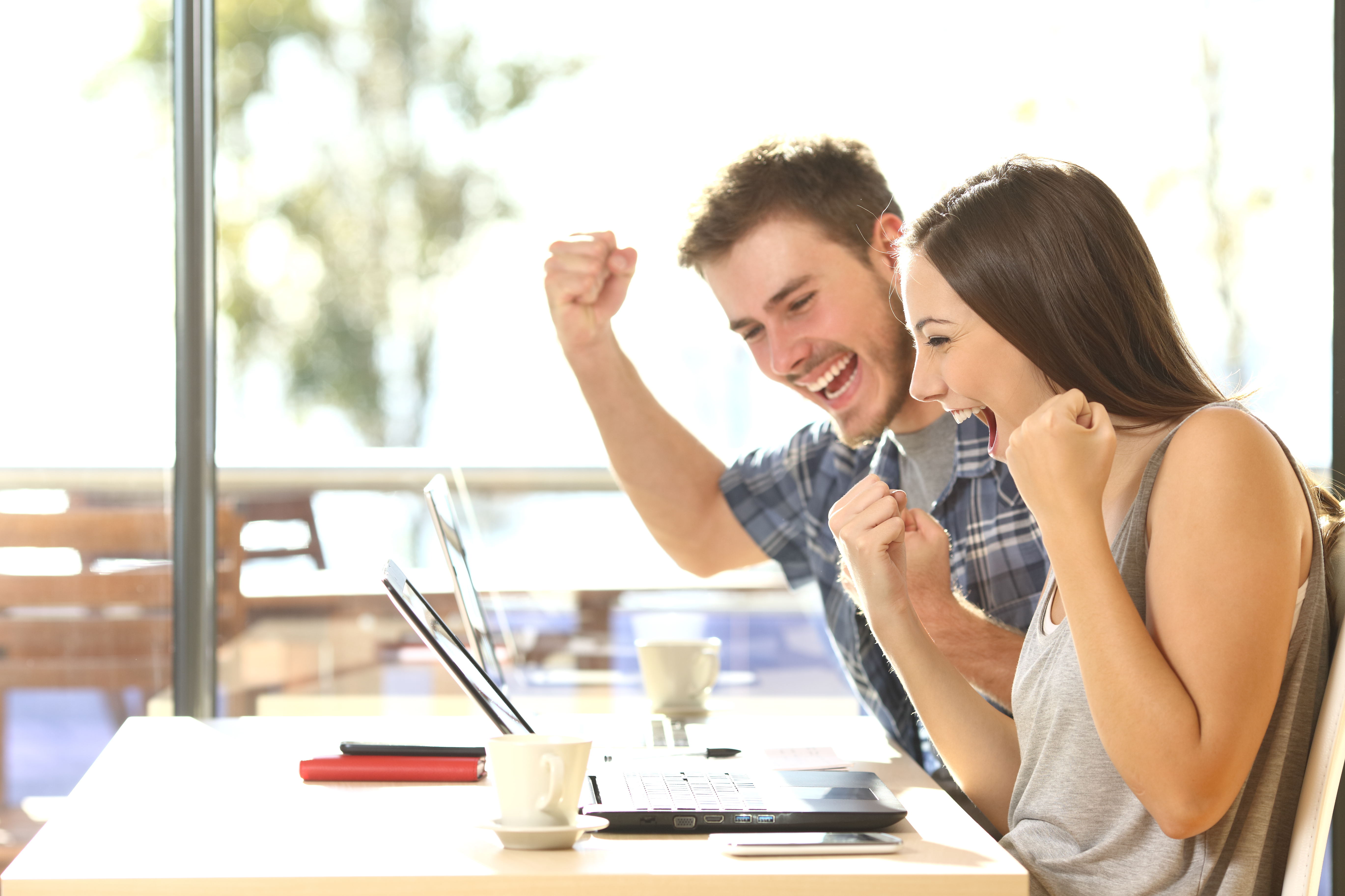 Group,Of,Two,Young,Euphoric,Students,Watching,Exam,Results,In